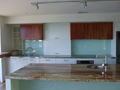 2Pak & veneer kitchen with back-lit glass splashbacks & onyx benchtop